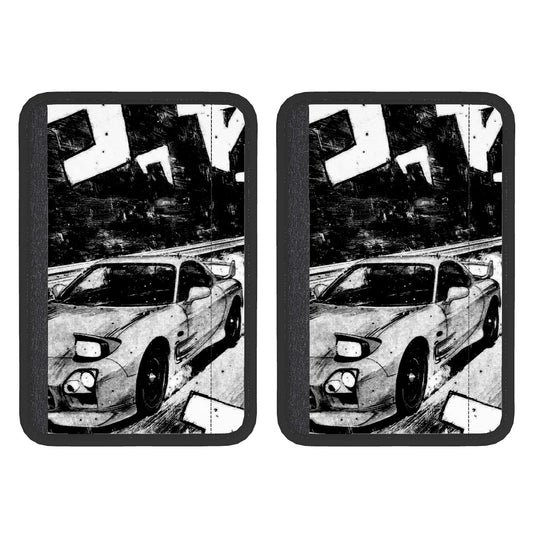 A pair of black neoprene seat belt cover pads with a white car graphic design on them.