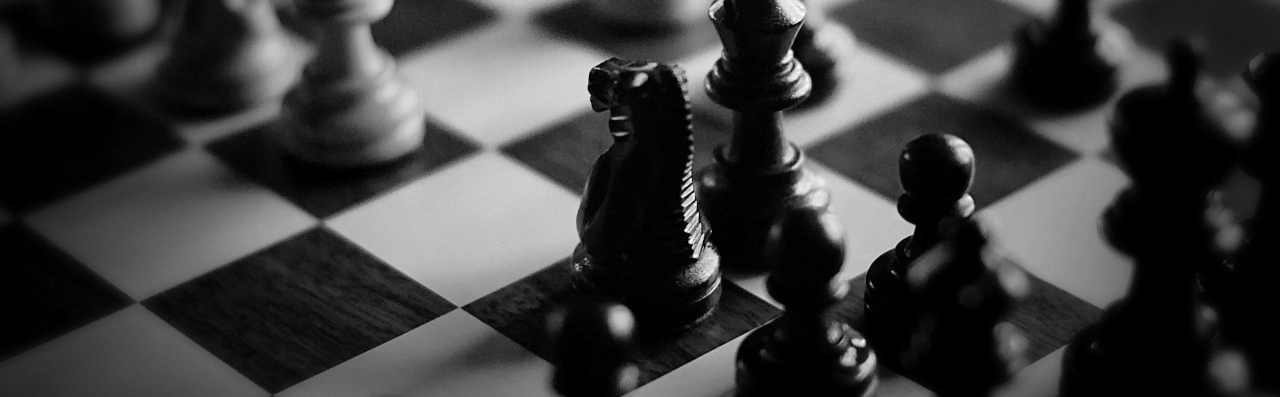 Black and white chess pieces on a chessboard