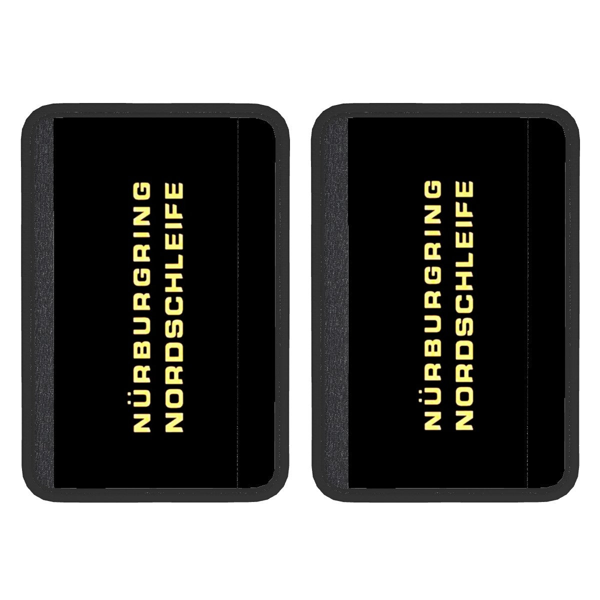Two black neoprene seat belt cover pads with 'Nürburgring Nordschleife' text in yellow, indicating a racing track, suggesting the product is designed for use in car seat belts.