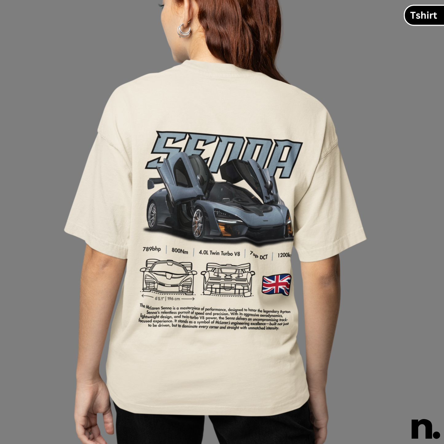 Person wearing a beige t-shirt with a car design and text on the back, on a gray background.