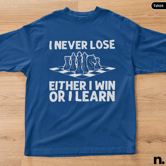 Blue t-shirt with chess design and text on a wooden surface