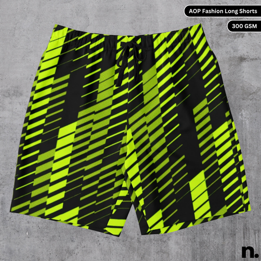 A flat lay of black and neon green all-over print shorts with a racing livery pattern, showcasing the drawstring closure and pockets.