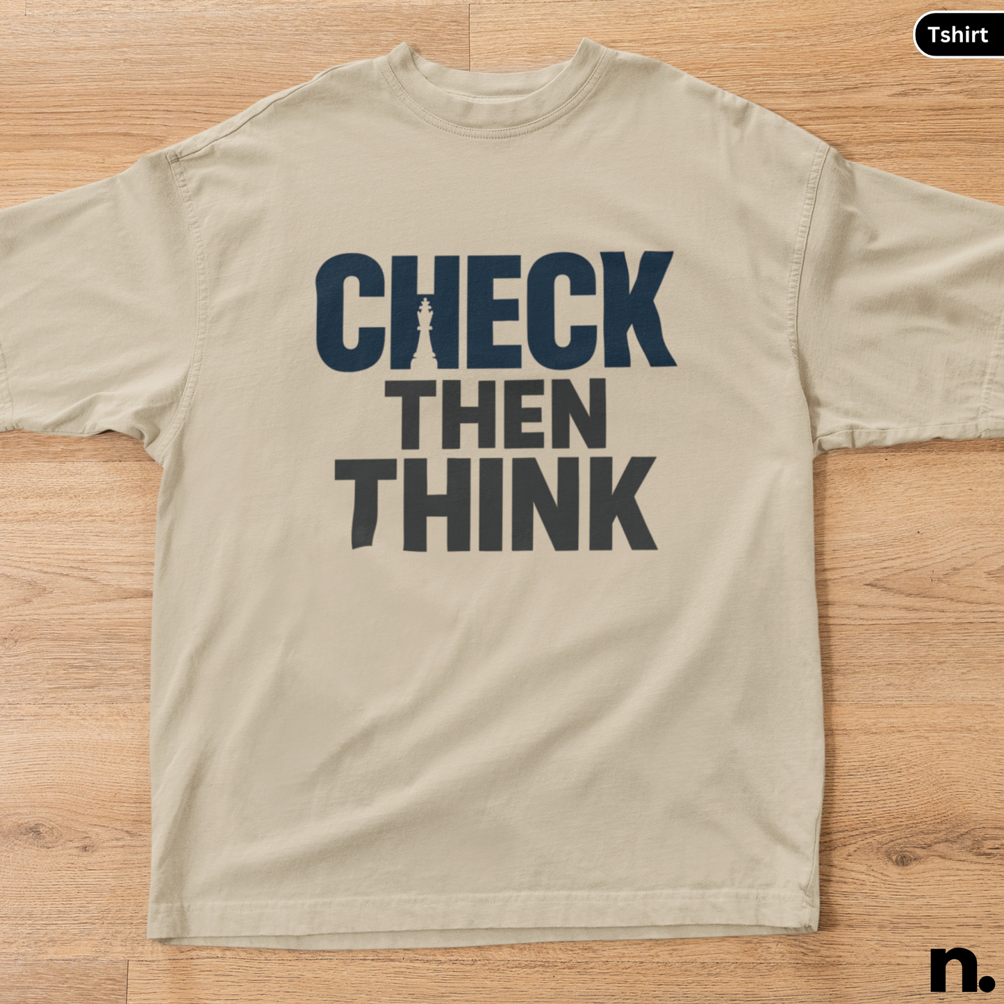 Beige t-shirt with 'Check Then Think' text on a wooden surface