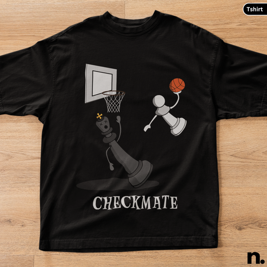 Black t-shirt with a graphic design of a chess piece playing basketball and the word 'CHECKMATE' on a wooden surface.