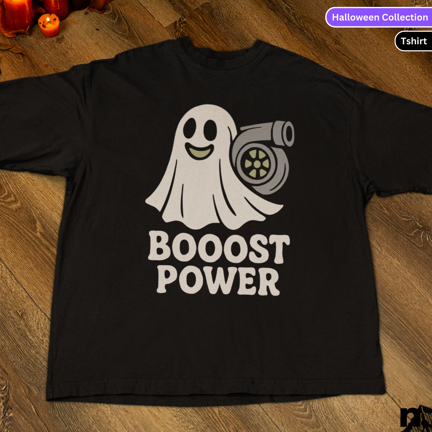 Black t-shirt with a ghost and turbo graphic and 'BOOSt POWER' text on a wooden surface.