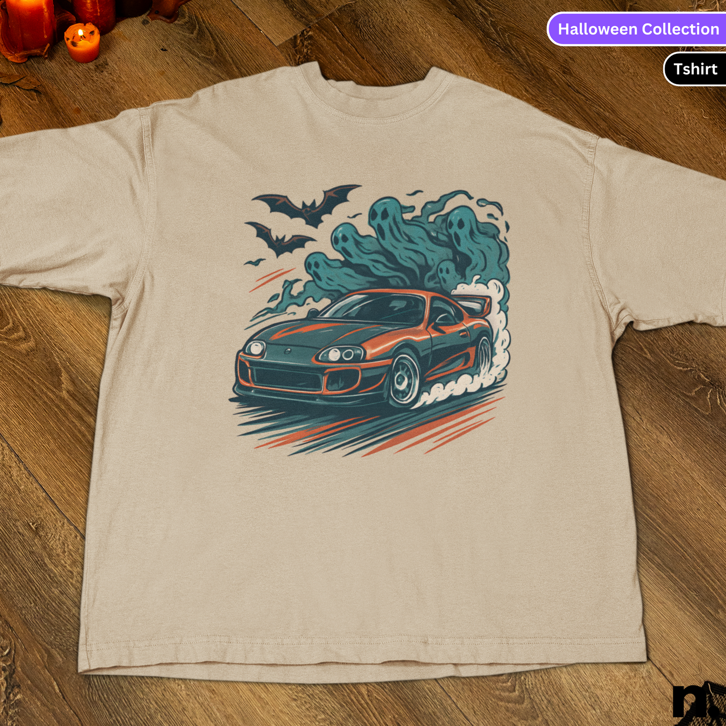 Beige t-shirt with a car graphic and ghost design on a wooden surface