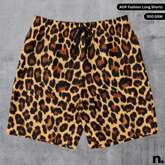 A flat lay of men's shorts with a bold all-over cheetah print pattern, showcasing the drawstring closure and side pockets.