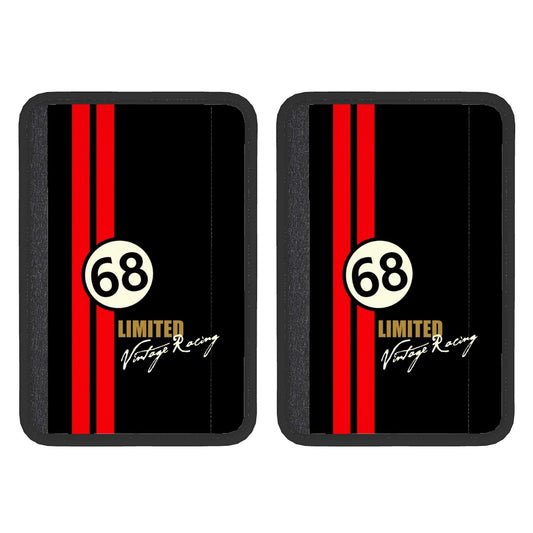 Two black neoprene seat belt cover pads with red and white racing stripe design and the text '68 LIMITED VINTAGE RACING'. They are displayed against a white background.
