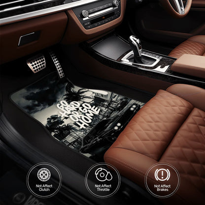 Car interior with a focus on the pedals and gear shift, featuring a black and white design on the floor mat.