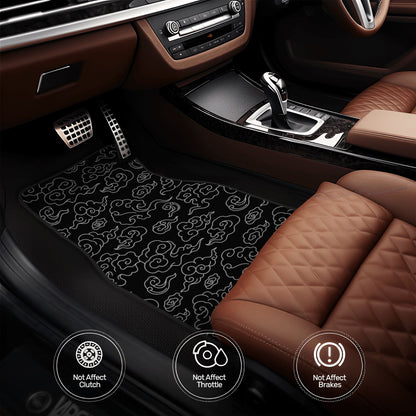 Car interior with a black patterned floor mat on a brown leather seat.