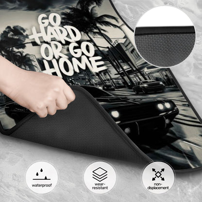 Car sunshade with 'Go Hard or Go Home' text, hand holding it, car in background.