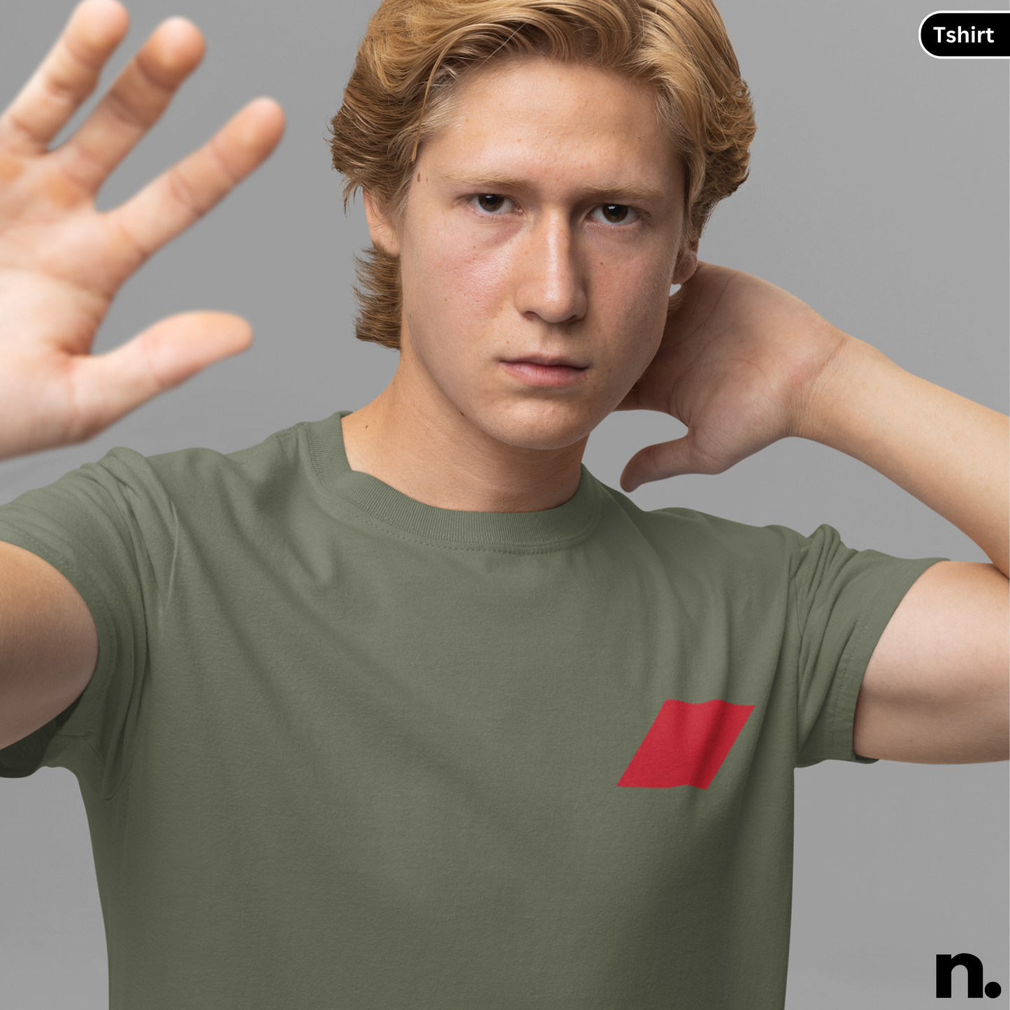 Man wearing a green t-shirt with a red logo on a gray background