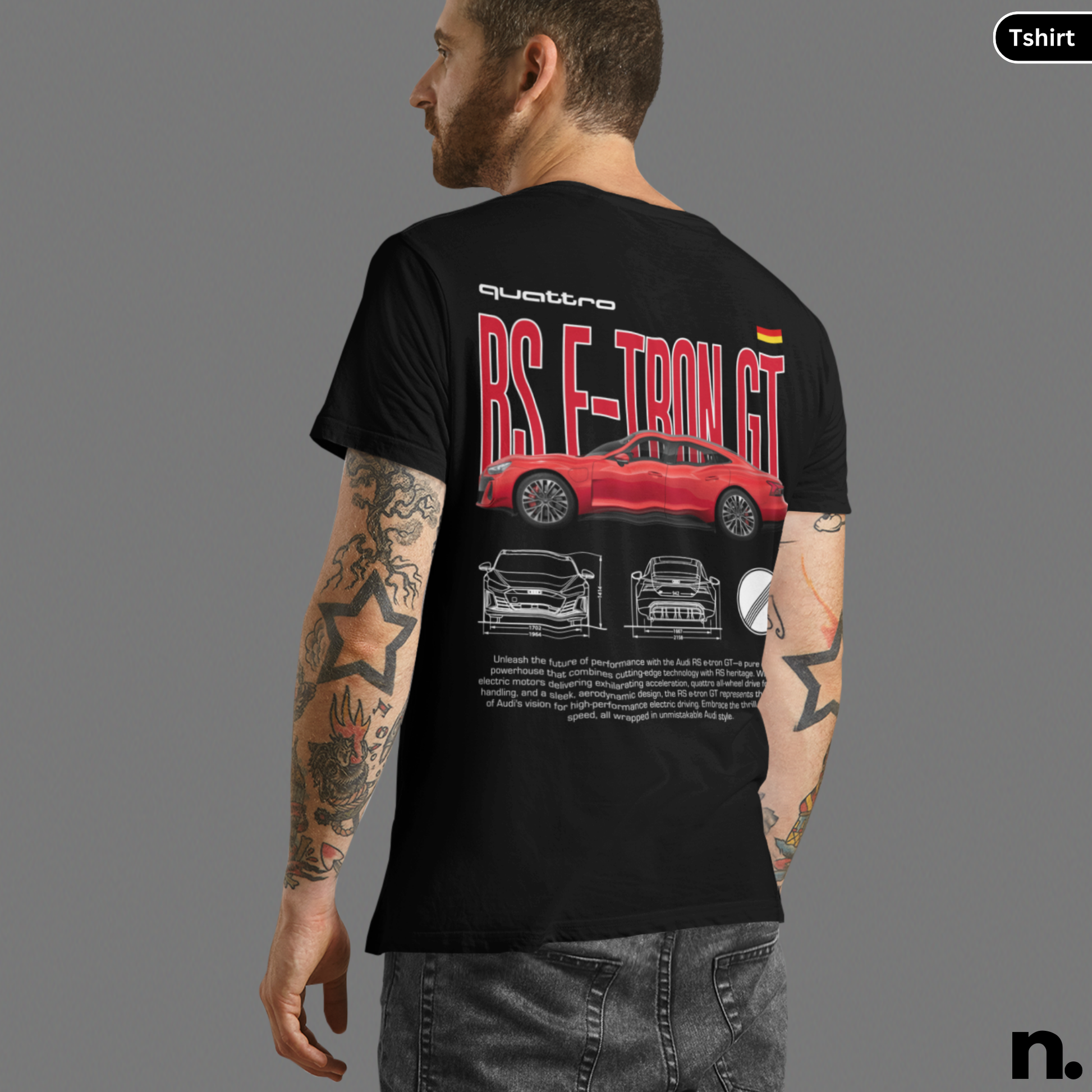 Person wearing a black t-shirt with car design and text on the back, on a gray background.