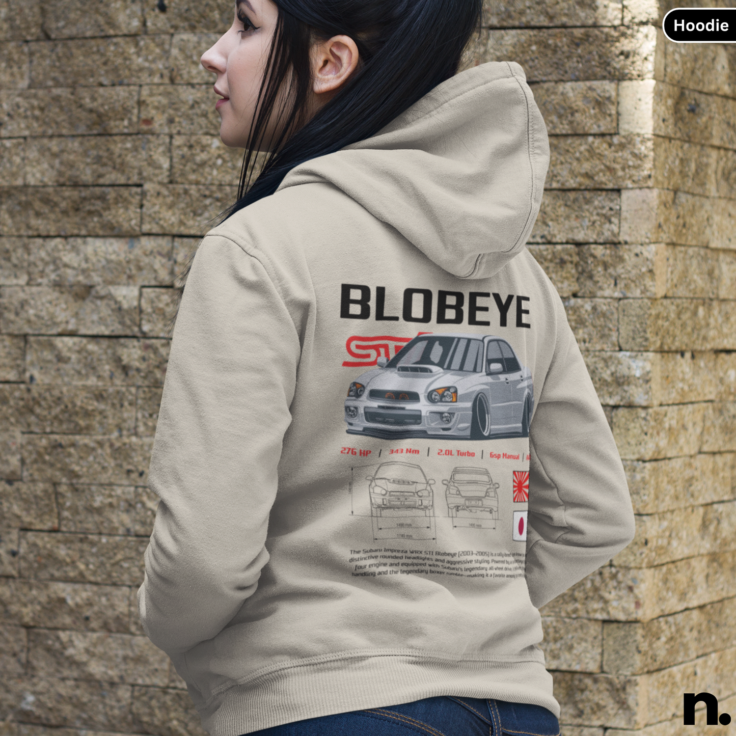 Person wearing a hoodie with 'BLOBEYE' design against a stone wall.