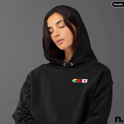Person wearing a black hoodie with a colorful logo on a gray background