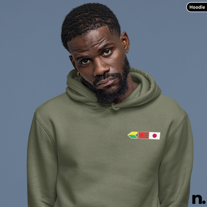 Man wearing a green hoodie with flag designs on a gray background
