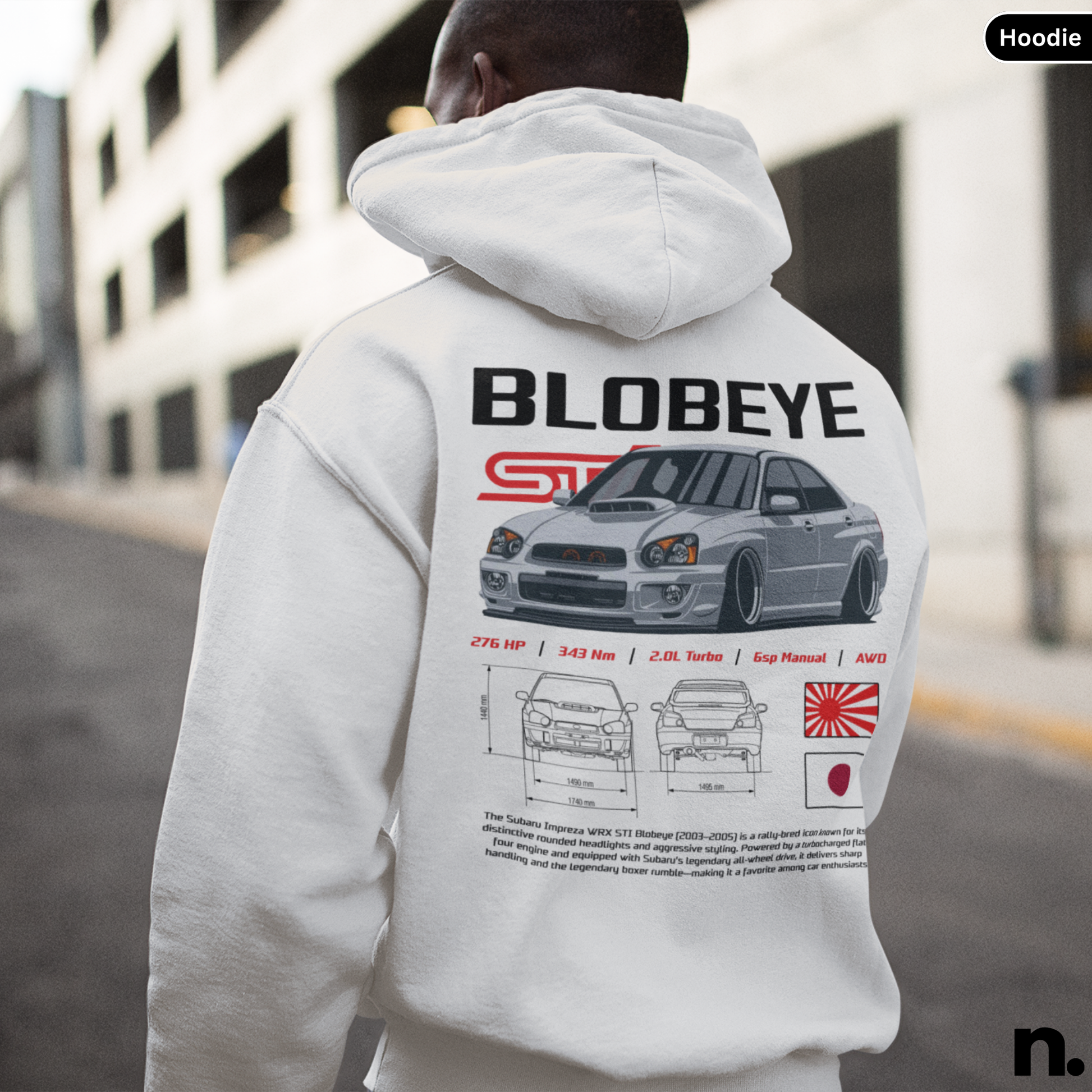 Person wearing a hoodie with 'Blobeye' car design on the back, standing in an urban setting.