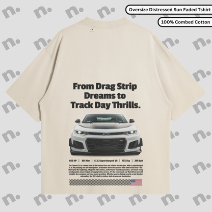 Flat lay of vintage-style oversized graphic tee with washed gradient and distressed details, inspired by classic muscle car energy.