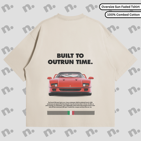 Flat lay of a premium black T-shirt featuring a vintage Ferrari F40 design with the text "Built to Outrun Time", styled with modern streetwear accessories on a neutral background.
