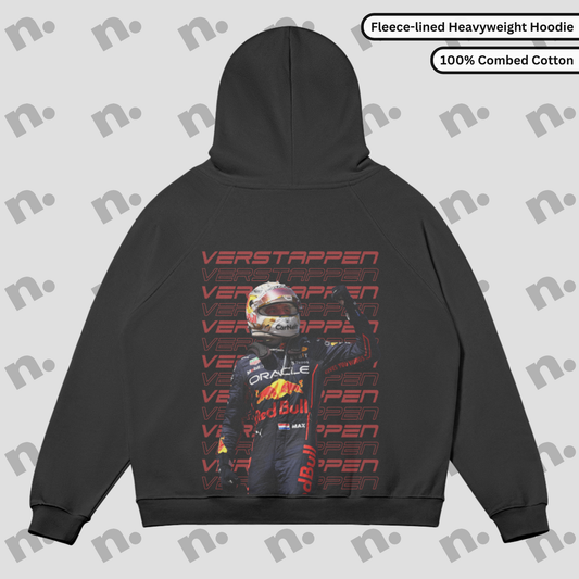 Flat lay of a premium hoodie featuring a bold Max Verstappen inspired design, styled with motorsport-themed accessories on a clean, neutral background.