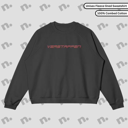 Flat lay of a premium sweatshirt featuring a bold Max Verstappen inspired design, paired with racing lifestyle accessories on a clean, neutral backdrop.