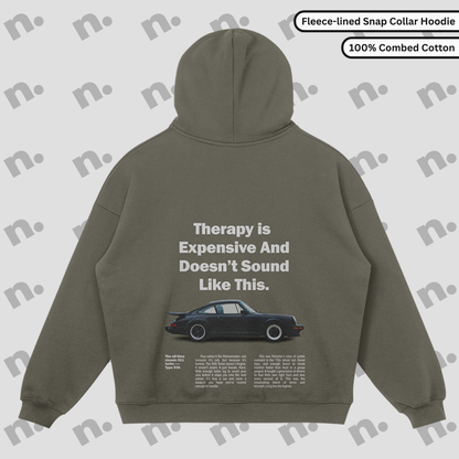 Flat lay of the 911 Therapy Snap Collar Fleece Premium Hoodie featuring a classic 911 graphic and 'Therapy is Expensive' slogan.