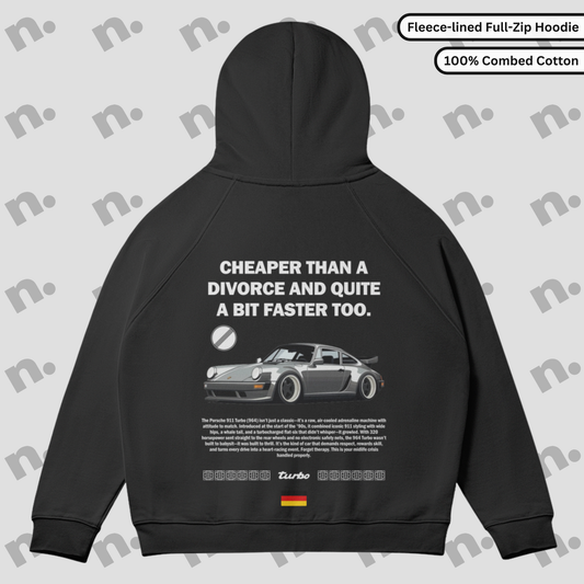 Flat lay of a full-zip fleece hoodie featuring a Porsche 964 Turbo inspired graphic with a humorous "Divorce" theme, styled with automotive lifestyle accessories on a neutral backdrop.