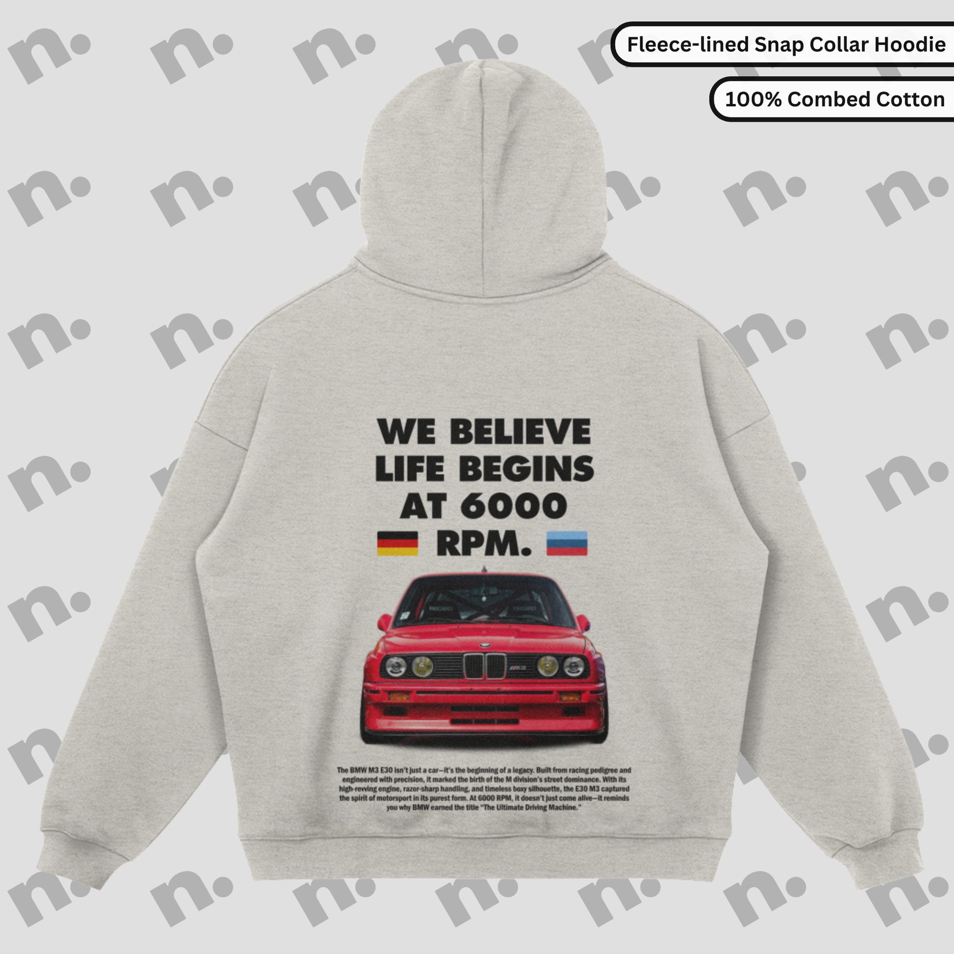 Flat lay of a premium snap-collar hoodie featuring a BMW E30 M3 design and the text "Life Begins at 6000 RPM", paired with minimalist accessories on a clean background.