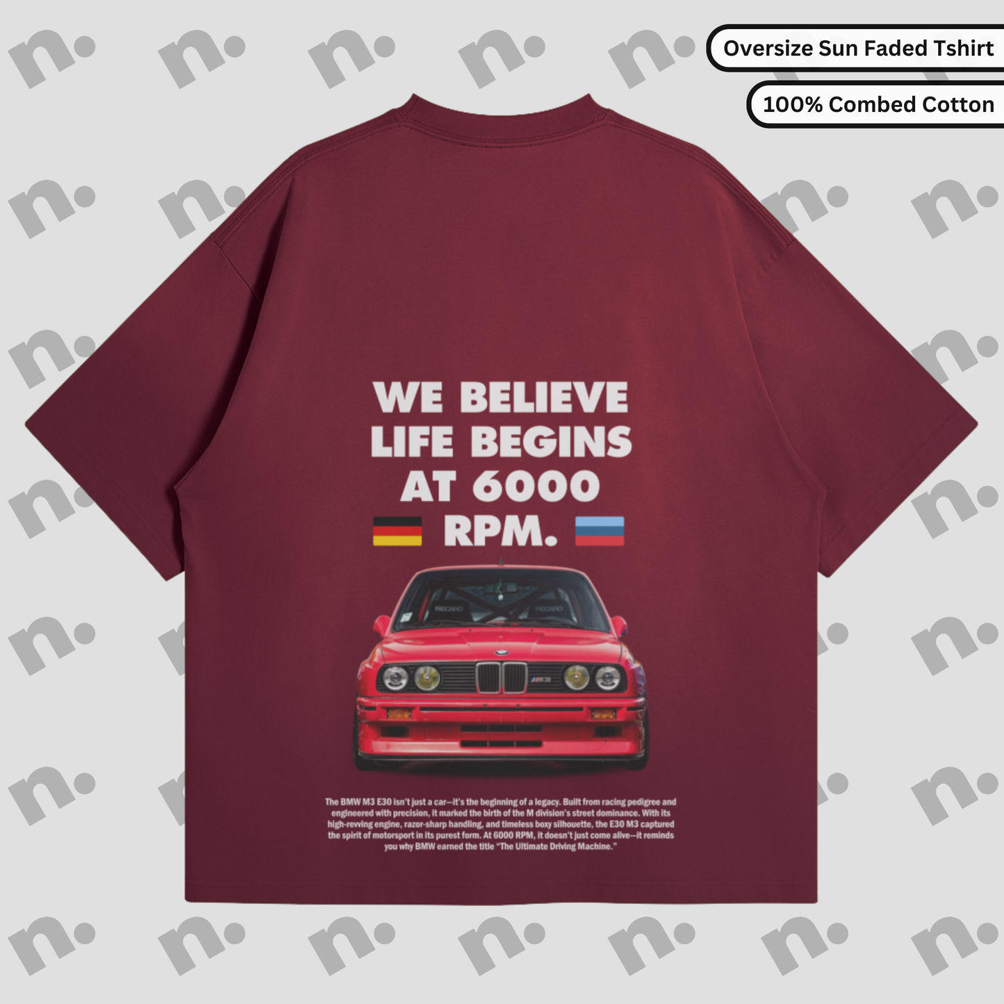 Flat lay of a dark-colored T-shirt featuring a minimalist BMW E30 inspired graphic, paired with modern streetwear accessories on a neutral background.