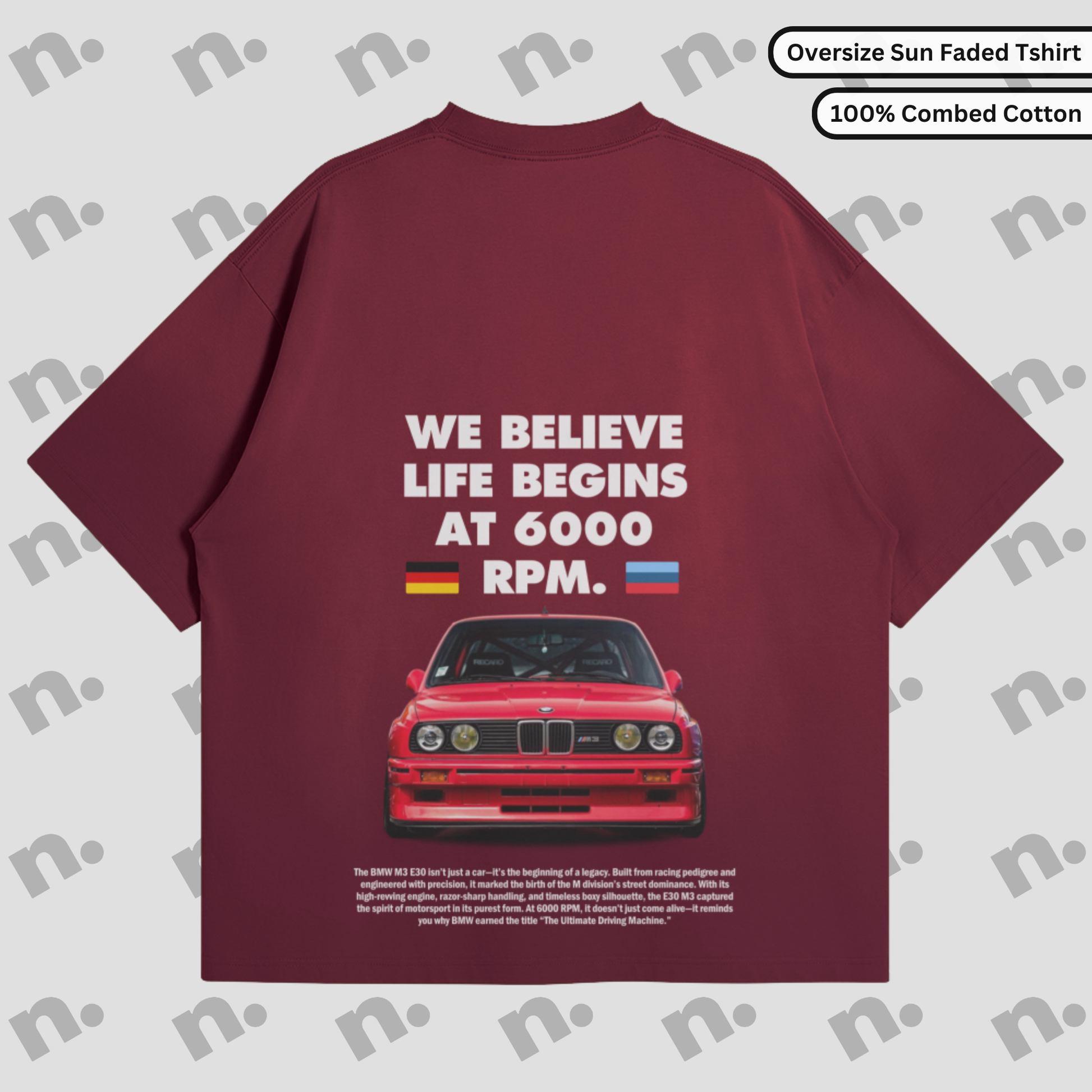 Flat lay of a dark-colored T-shirt featuring a minimalist BMW E30 inspired graphic, paired with modern streetwear accessories on a neutral background.