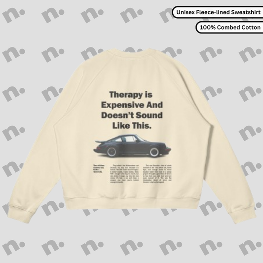Flat lay of the 911 Therapy Fleece-Lined Premium Sweatshirt featuring a classic 911 graphic and 'Therapy is Expensive' slogan.
