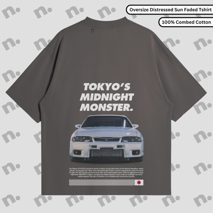 Flat lay of oversized washed-effect t-shirt featuring “TOKYO’S MIDNIGHT MONSTER.” GTR R33 design with distressed edges and tonal gradient, inspired by vintage Japanese street racing culture.
