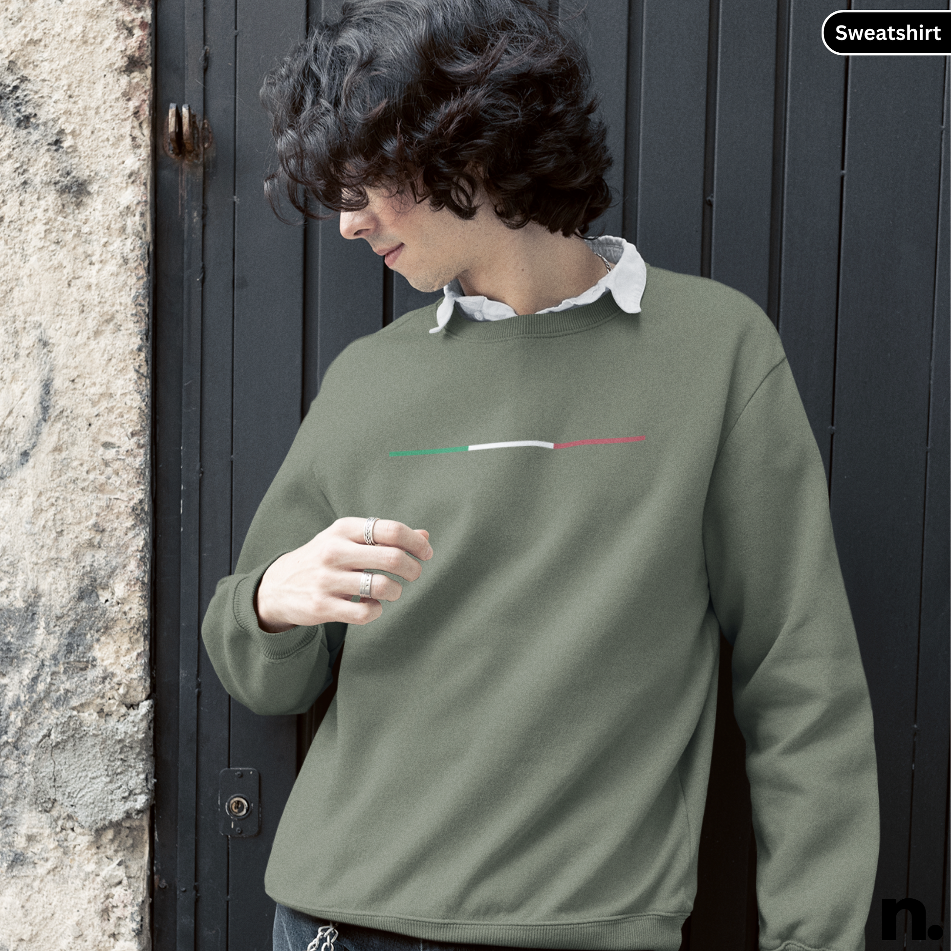 Person wearing a green sweatshirt with a small design on the chest, standing against a dark door. Abarth 500 Poster Style Sweatshirt