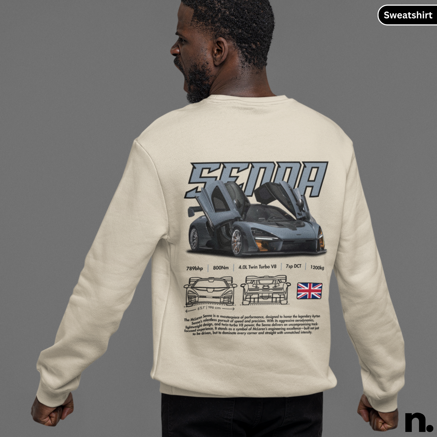 Person wearing a beige sweatshirt with car design and 'Senna' branding on the back.