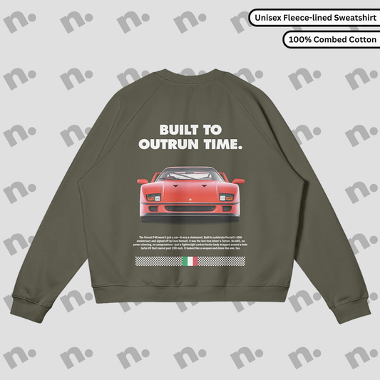 Flat lay of a premium black sweatshirt featuring a bold Ferrari F40 graphic and the slogan "Built to Outrun Time", styled with casual urban wear on a neutral backdrop.

