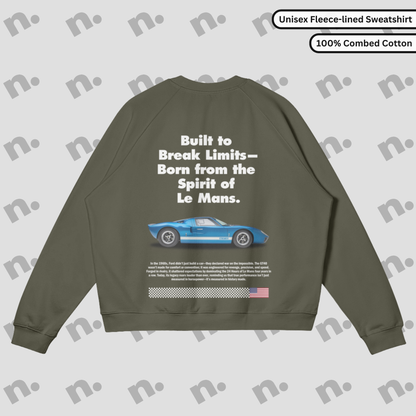 Flat lay of a fleece-lined premium sweatshirt featuring a vintage GT40 inspired design, styled with racing-inspired accessories on a clean, neutral background.