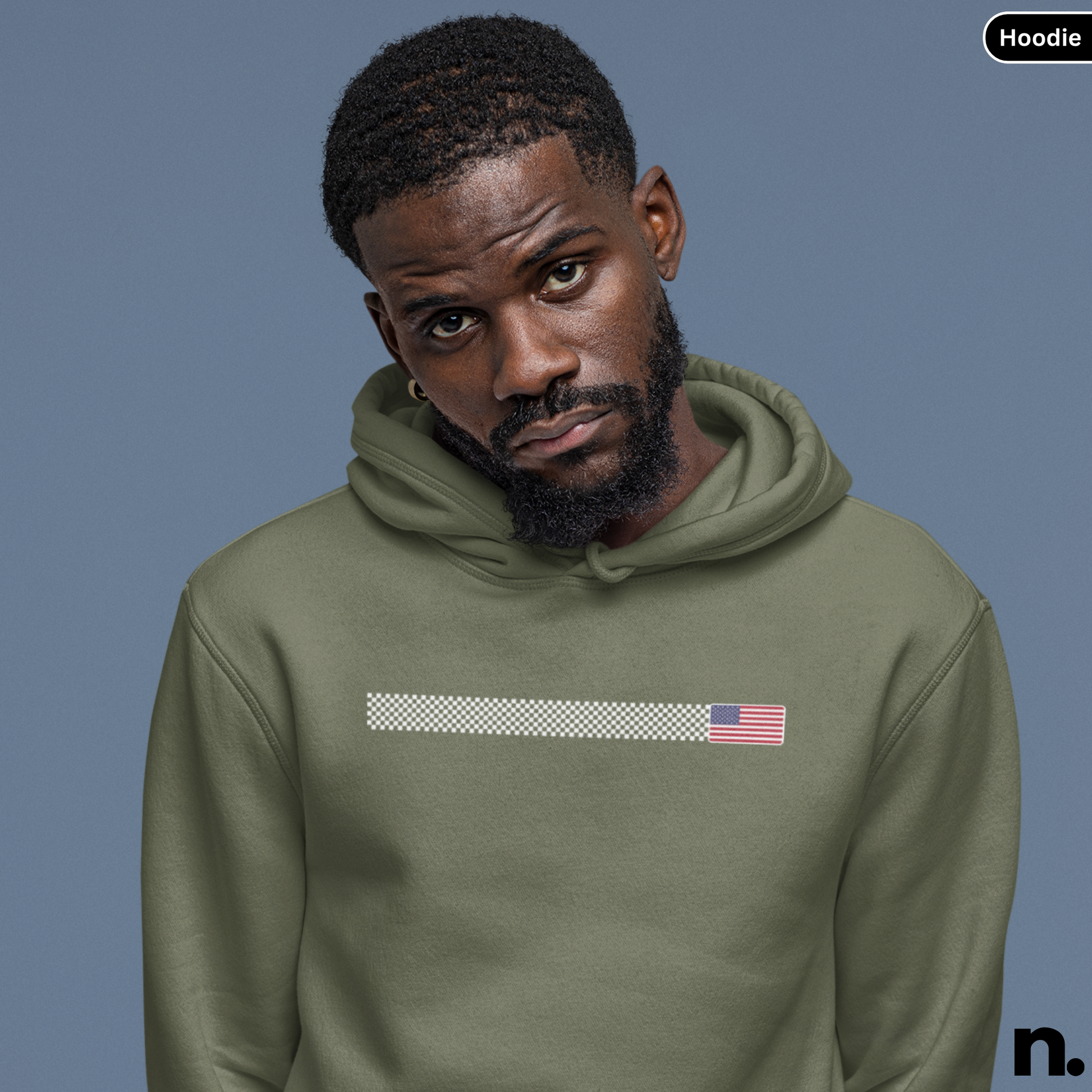 Man wearing a green hoodie with an American flag design on a blue background