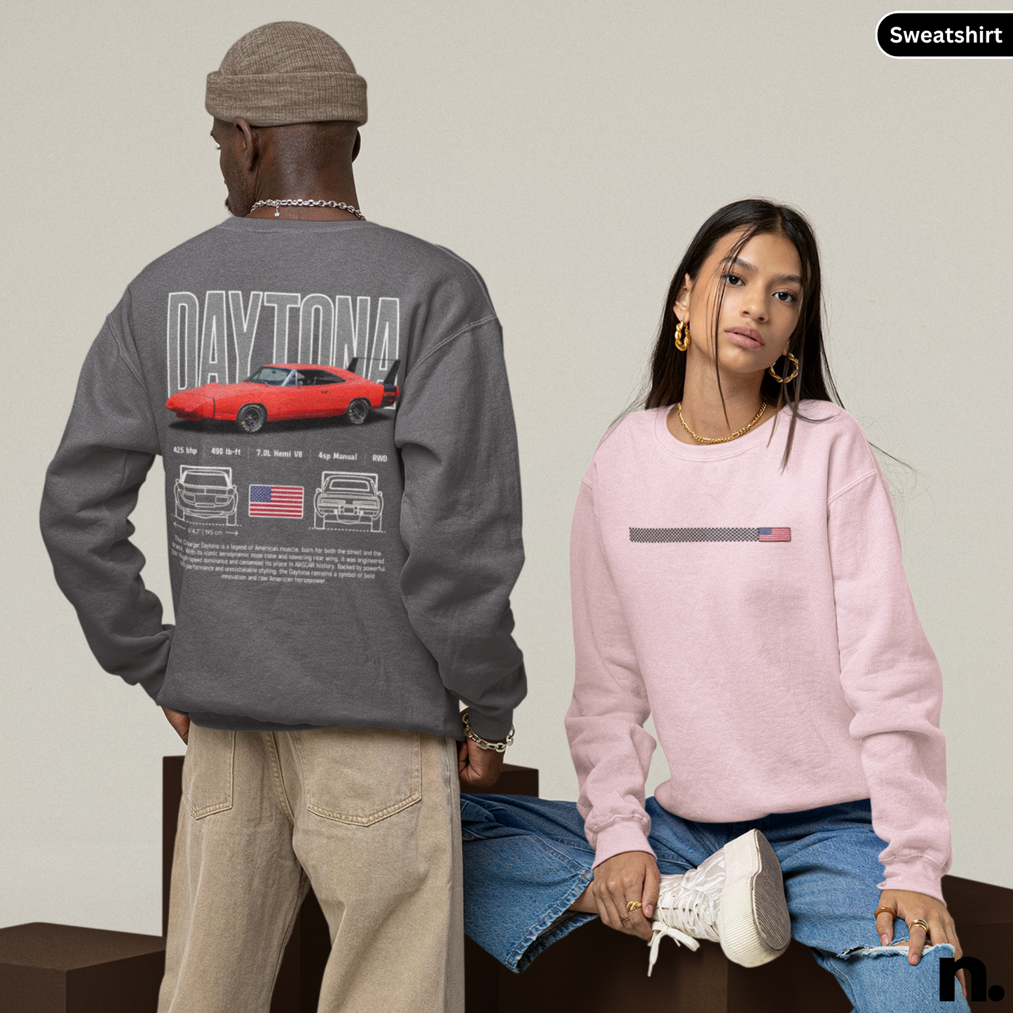 Two people wearing sweatshirts with car-themed designs on a neutral background