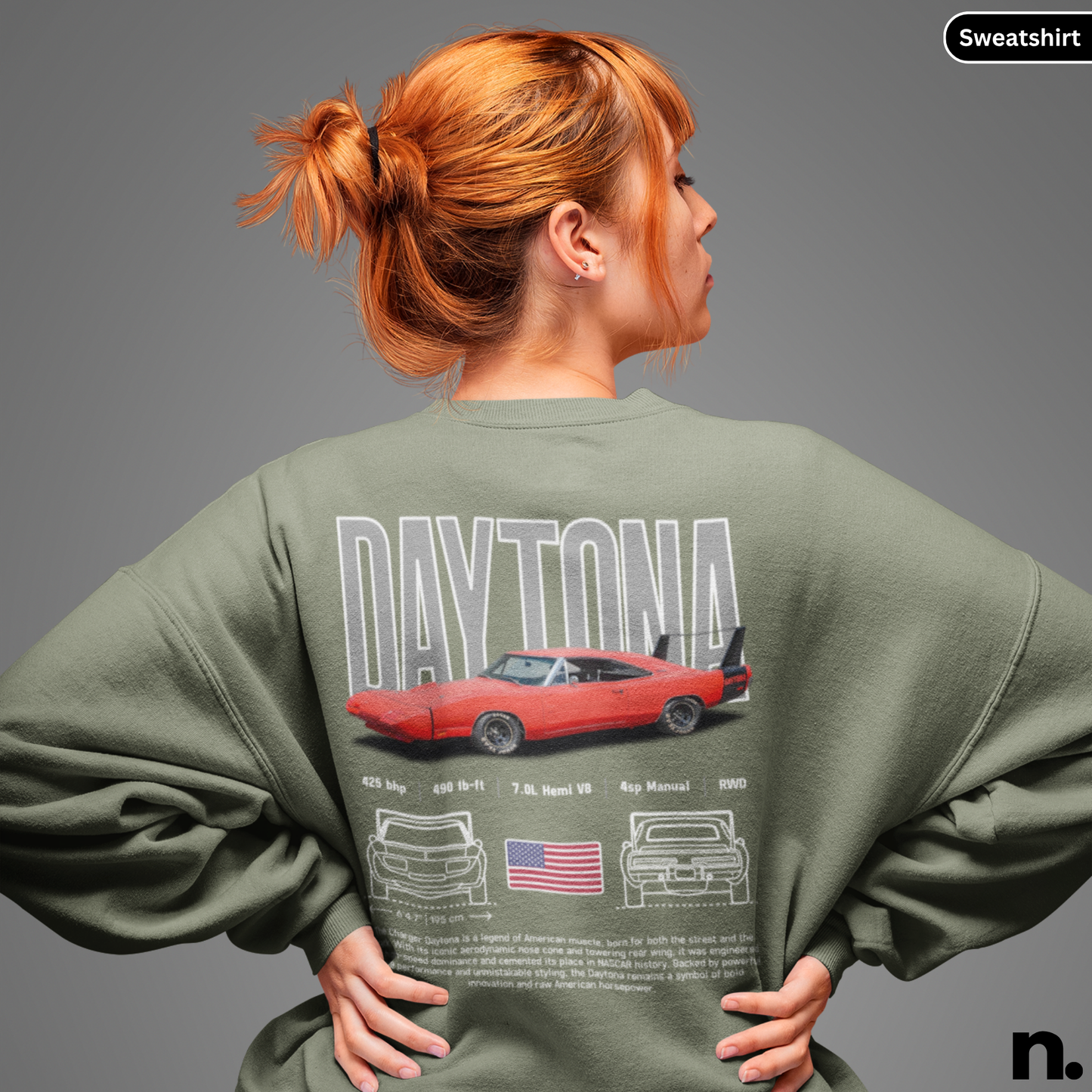 Person wearing a green sweatshirt with 'Daytona' design on the back, featuring a red car and American flag.