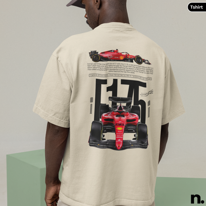 Person wearing a beige t-shirt with Formula 1 car graphics on the back, standing against a plain background.