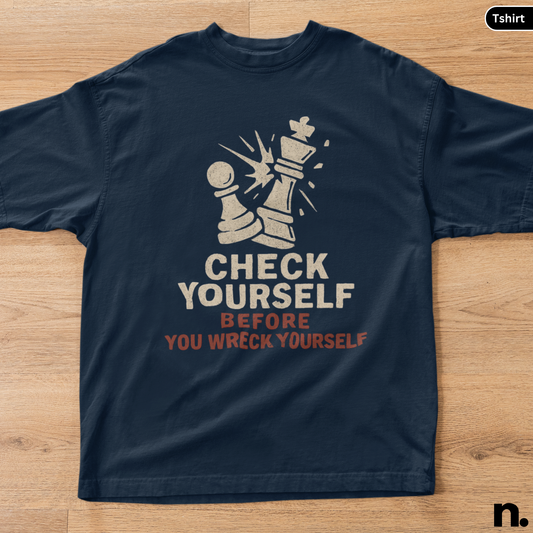 Navy blue t-shirt with chess piece graphic and text on a wooden surface