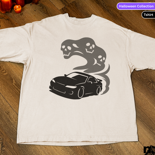 White t-shirt with black car and snake design on a wooden surface, labeled 'Halloween Collection'.