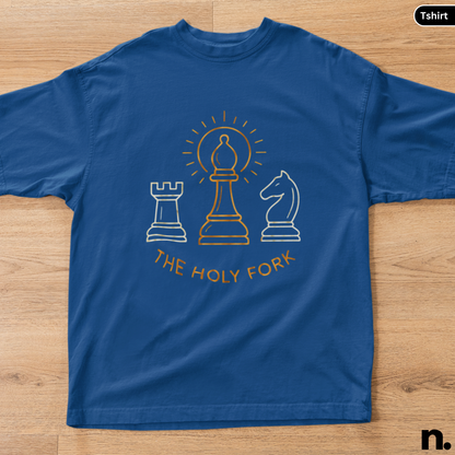 Blue t-shirt with chess piece graphics and 'The Holy Fork' text on a wooden surface