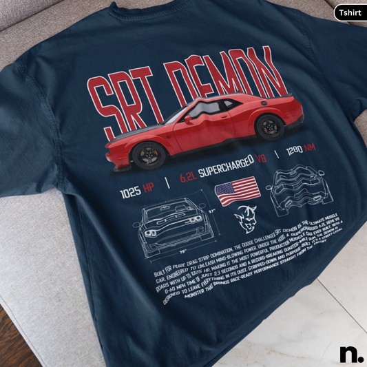 Navy blue t-shirt with red car graphic and text on a gray surface