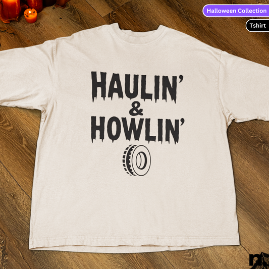 White t-shirt with 'HAULIN' & HOWLIN'' text on a wooden surface