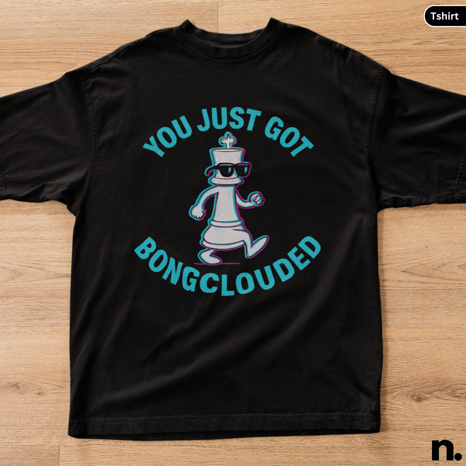 Black t-shirt with a graphic design and text on a wooden surface