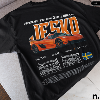 Black t-shirt with orange sports car design and text on a gray surface