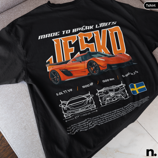 Black t-shirt with orange sports car design and text on a gray surface
