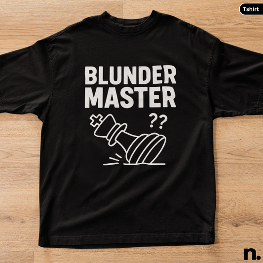 Black t-shirt with 'Blunder Master' text and graphic on a wooden surface