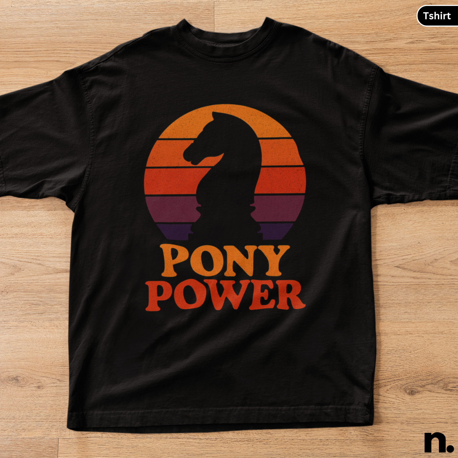Black t-shirt with 'Pony Power' graphic on a wooden surface